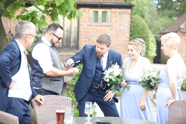 magician performing in front of guests and bridesmaids