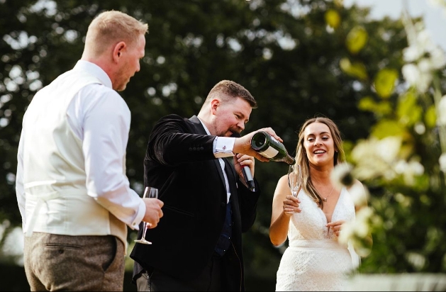 magician performing in front of guests and bridesmaids