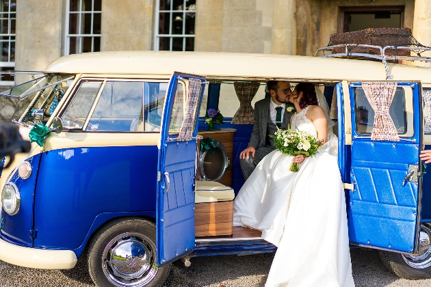 Newlywed couple kiss in campervan