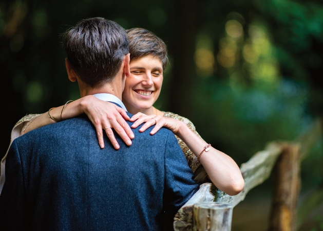 man and woman embracing on a bench