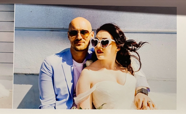 couple in the sun with sunglasses on in wedding attire