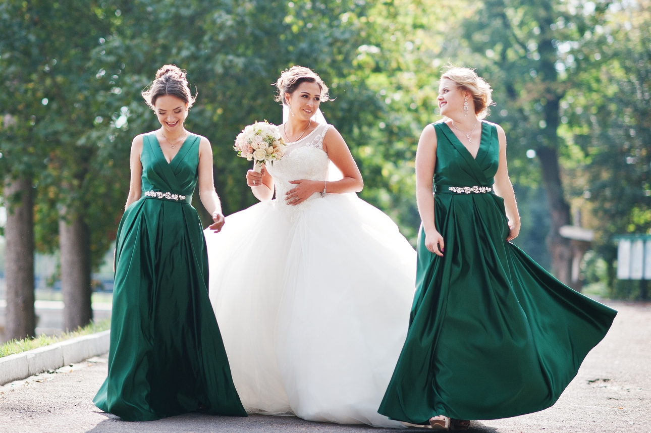 bride and bridesmaids walking down the street