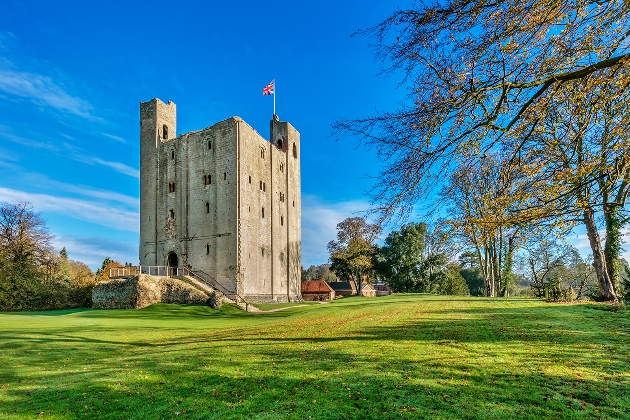 Hedingham Castle on a sunny day surrounded by grass and trees