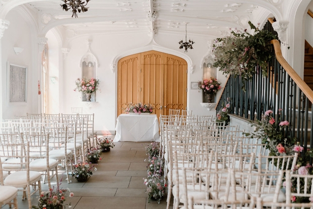ceremony setting with aisle, chairs and flowers 