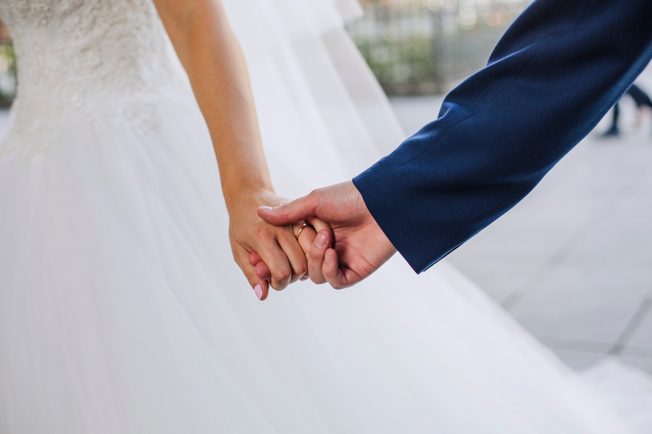 couple holding hands on their wedding day