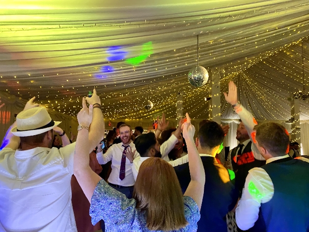 guests dancing at wedding in marquee 
