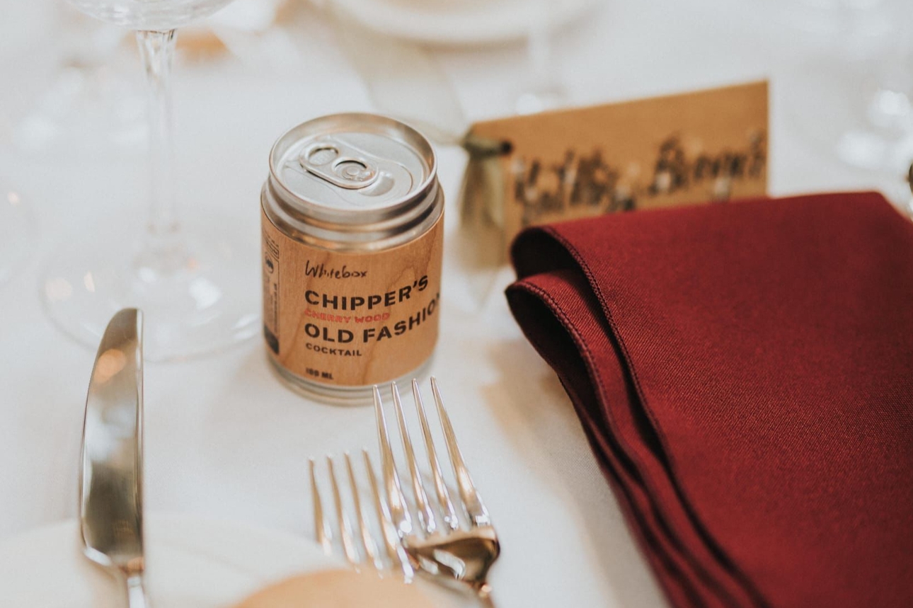 cocktail in a can with label, wooden design, on wedding table