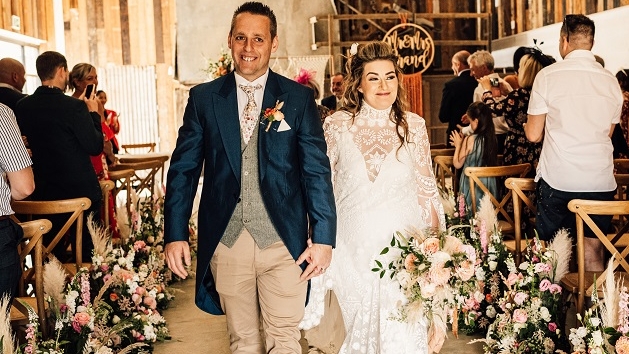 bride and groom walk down the aisle