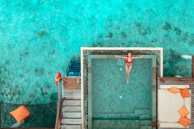 Beautiful woman enjoying swimming pool on ocean side