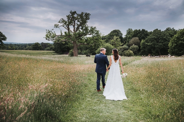 couple walking in countryside at venue