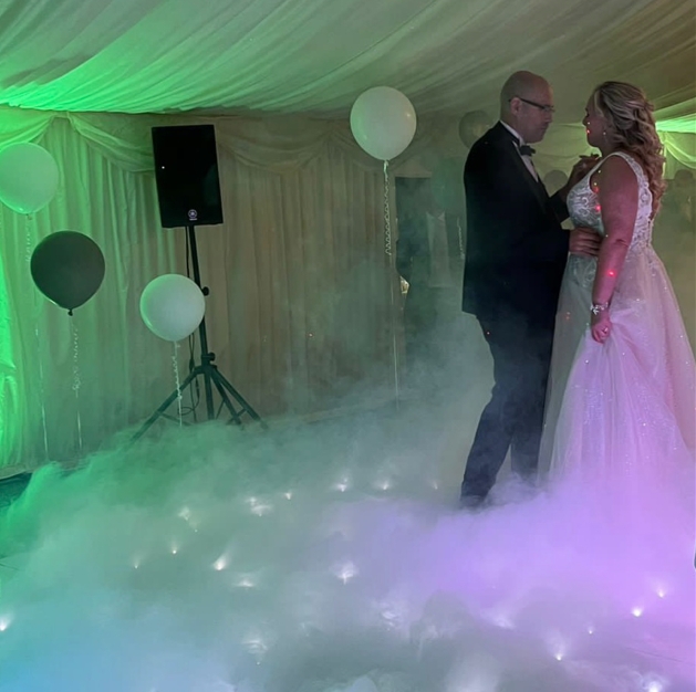 couple dancing in marquee with smoke machine on floor