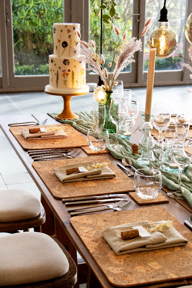 clos up of table set up for wedding with cake in background 