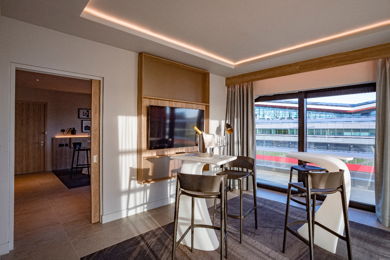 suite with tables and chair looking at race track