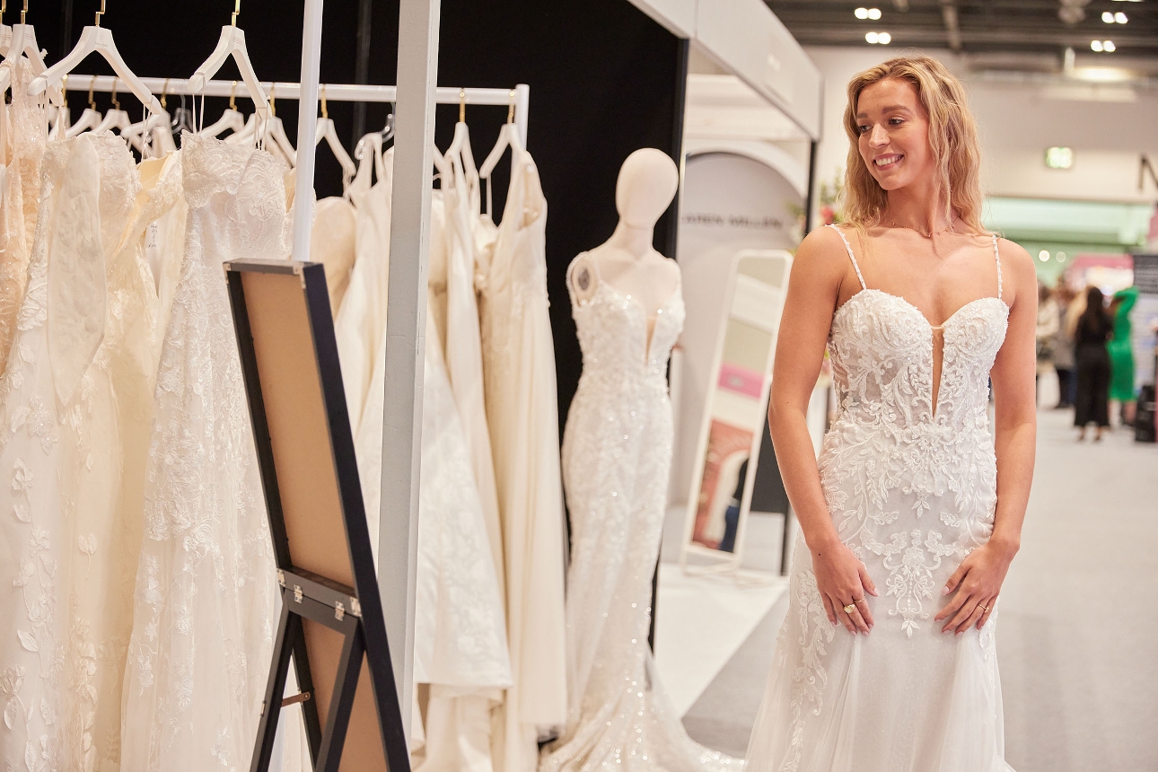 woman trying on dresses at show