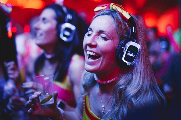 woman with headphones on for silent disco