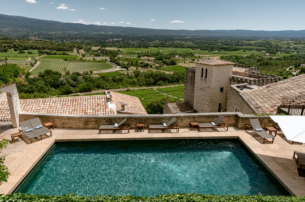 pool on terrace with hillside views