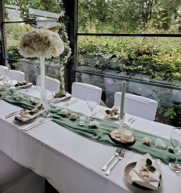 table set up at wedding with green theme