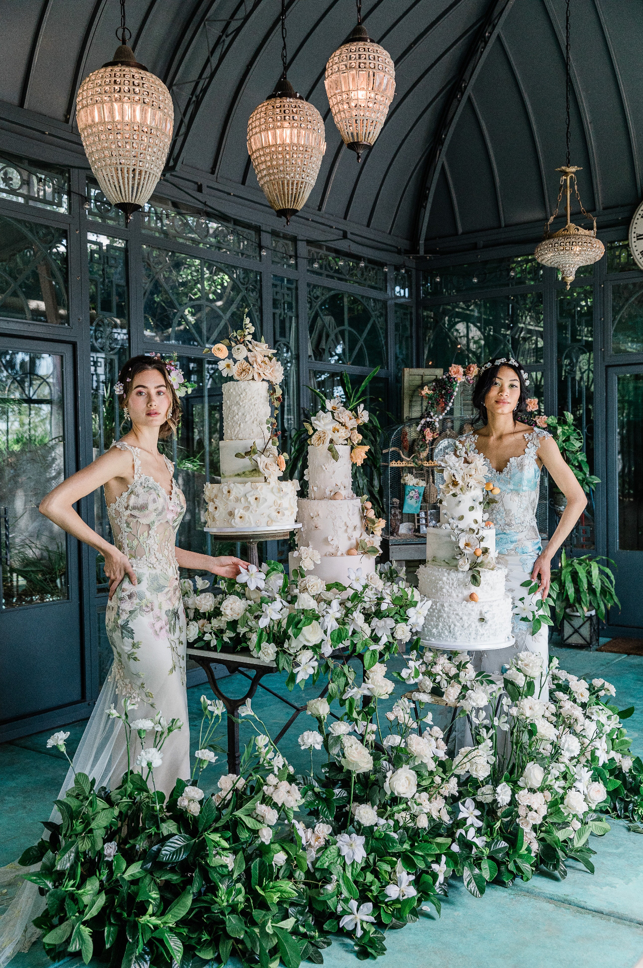 two models in floral inspired dresses next two floral decorated cakes