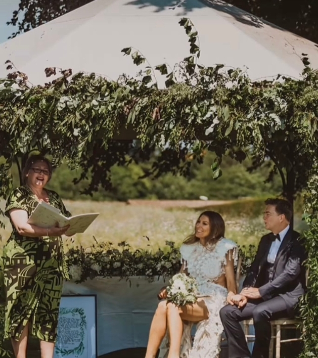 celebrant with couple at wedding