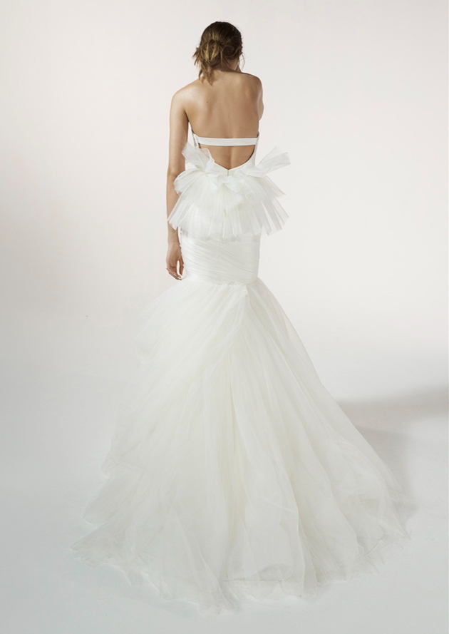 model in white dress fishtail style with back layered rouche at base and frill skirt