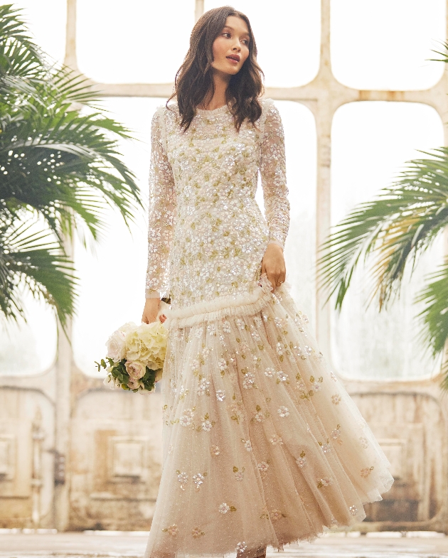 gream and gold thigh waisted gown with heavy bead detail long sleeves and skirt and high neckline