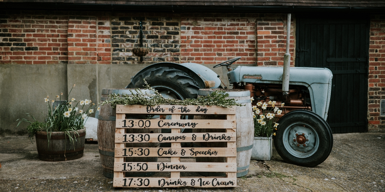 wooden pallet with writing on propped up on tractor