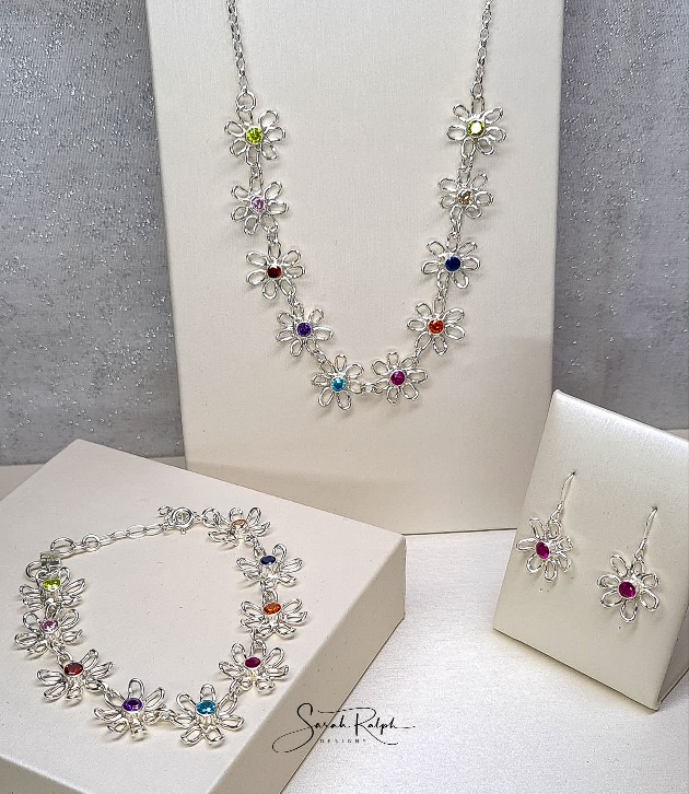 silver flower set colour gemstones in middle