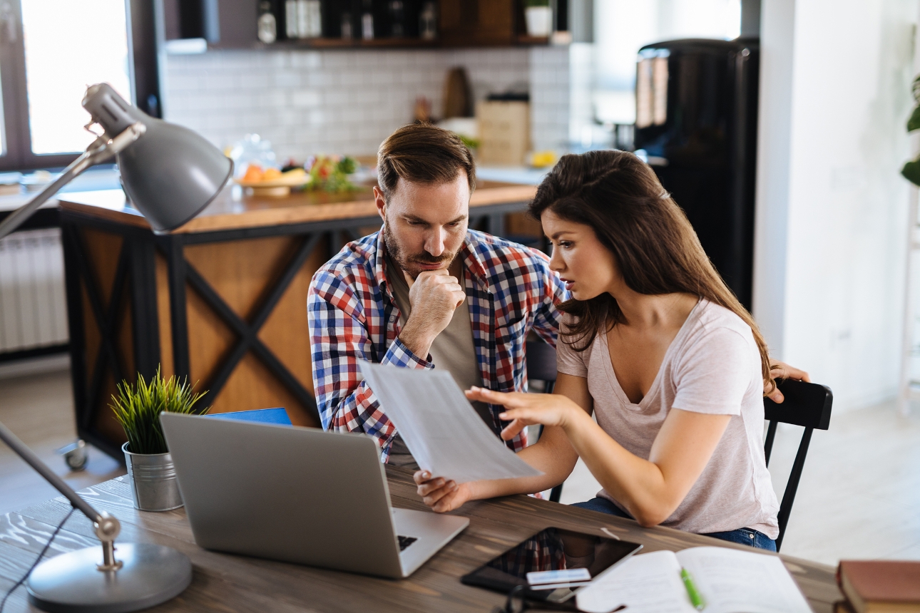 couple sat at table look at finances