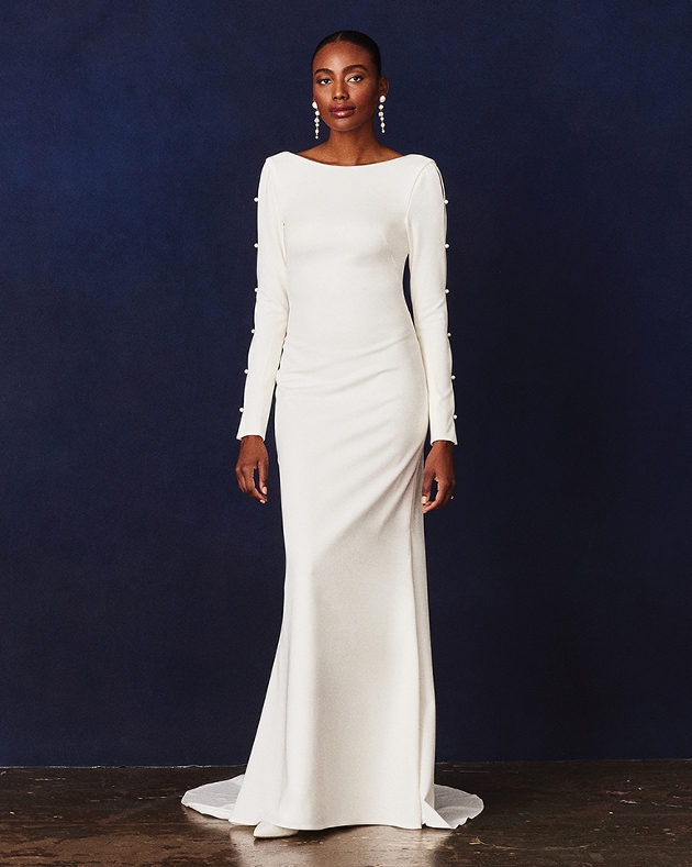 model in long close fit gown with long sleeves adorned with a line of perals