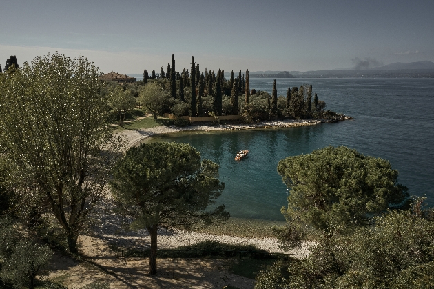 A large lake with lots of trees on the shore