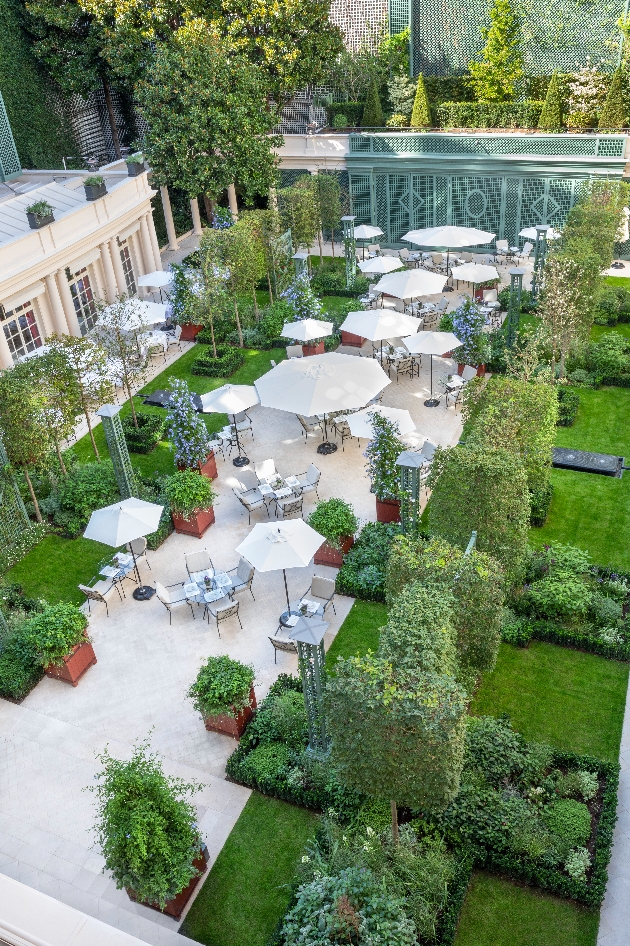 hotel 's manicured gardens with table and chairs 