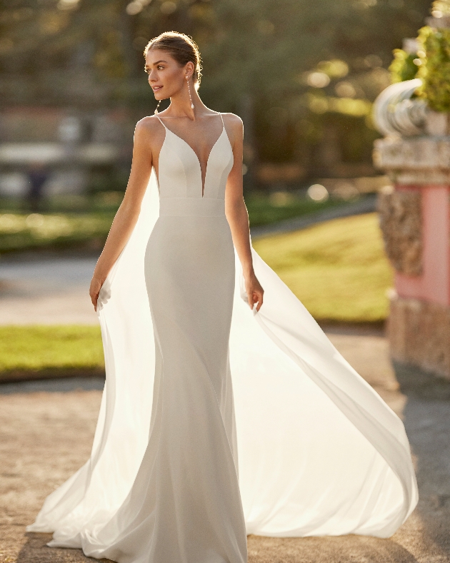 model in fishtail gown with spaghetti straps, plunging neckline