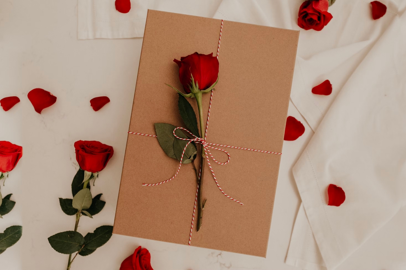 rose tied to a brown envelope 