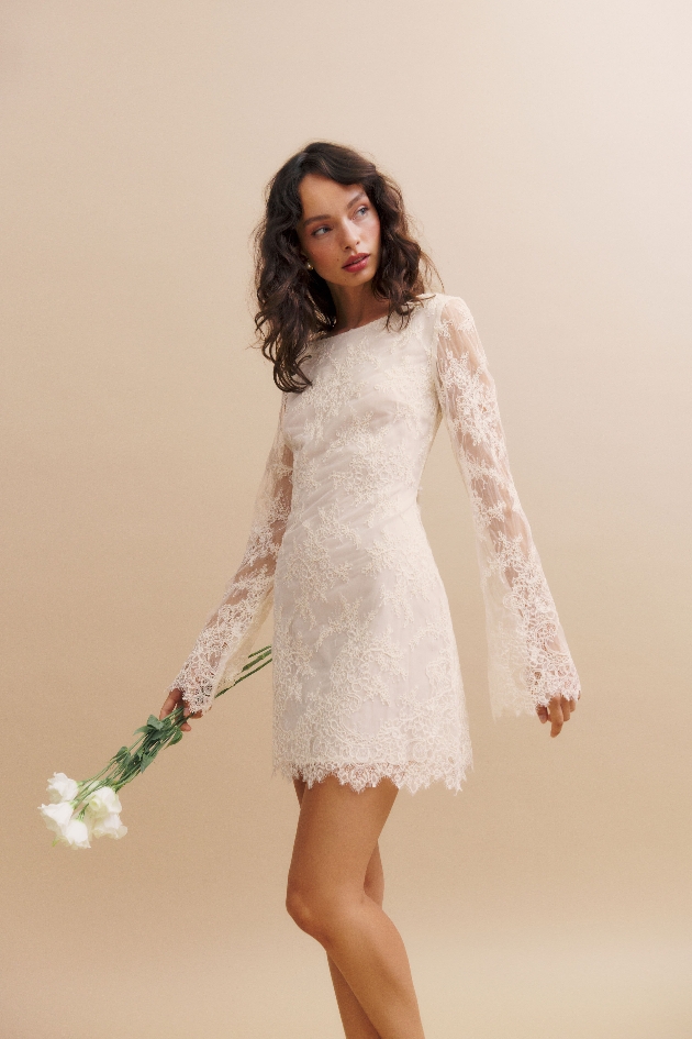model in short lace dress with long sleeves