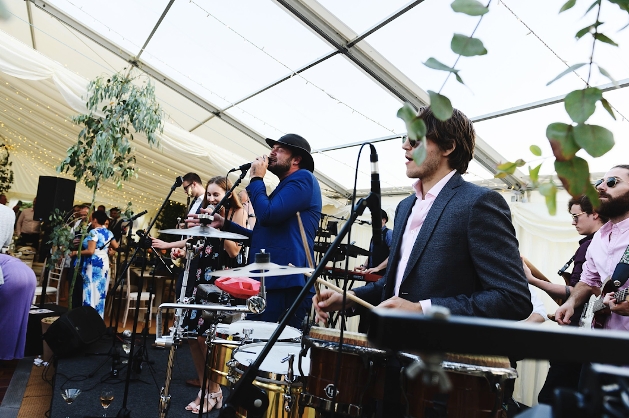 band and singers in a marquee