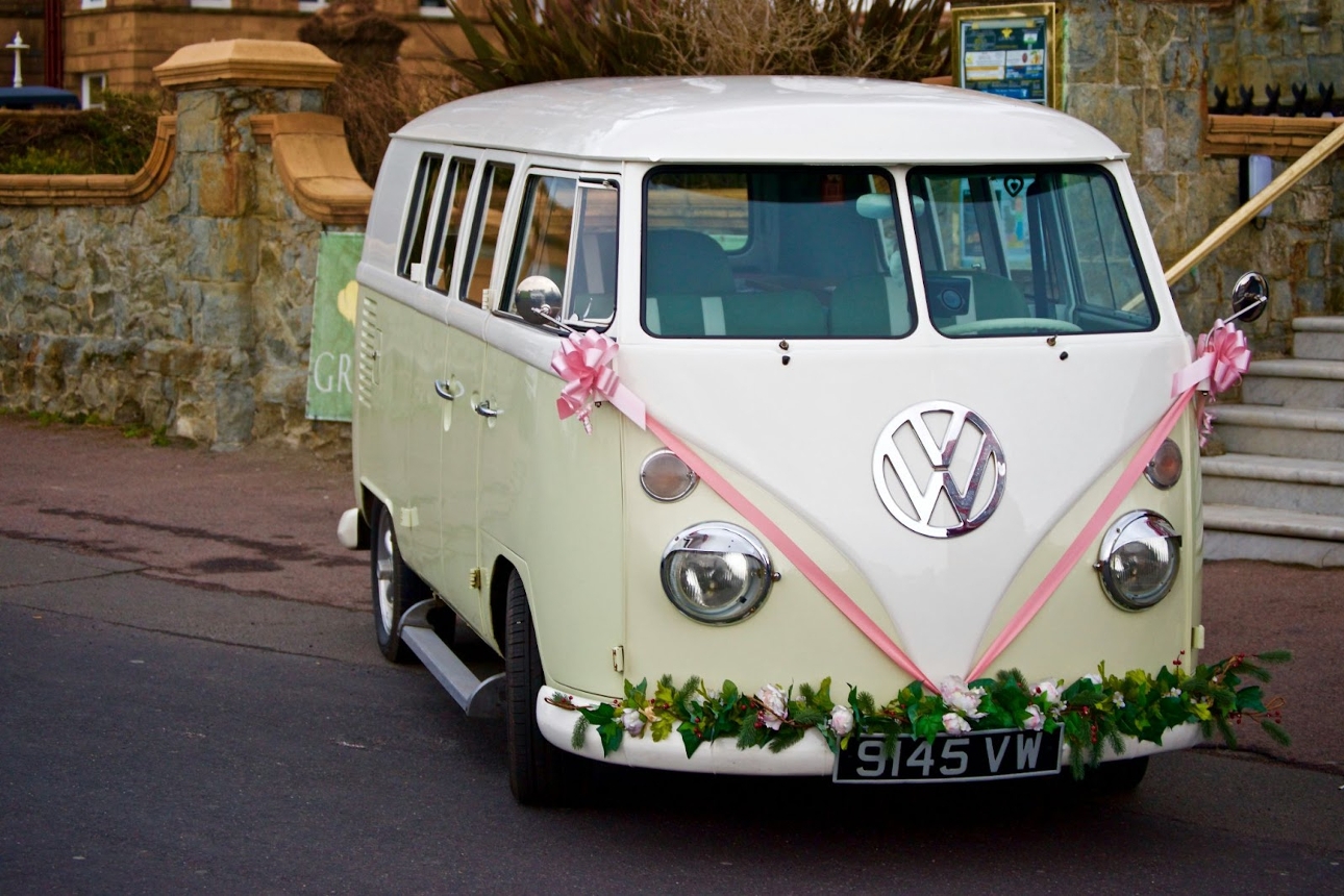 VW Camper Van green with white roof and pink ribbons