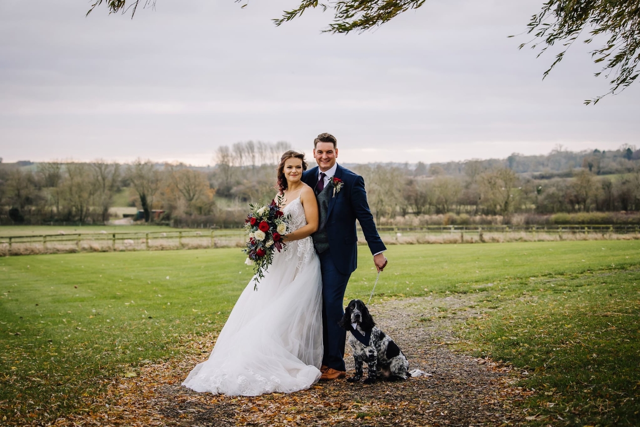 bride and groom on their wedding day with their dogs