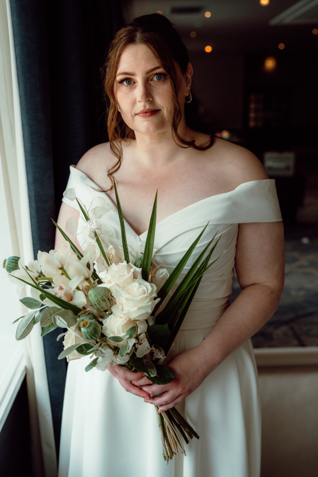 bride in dress holding bouquet