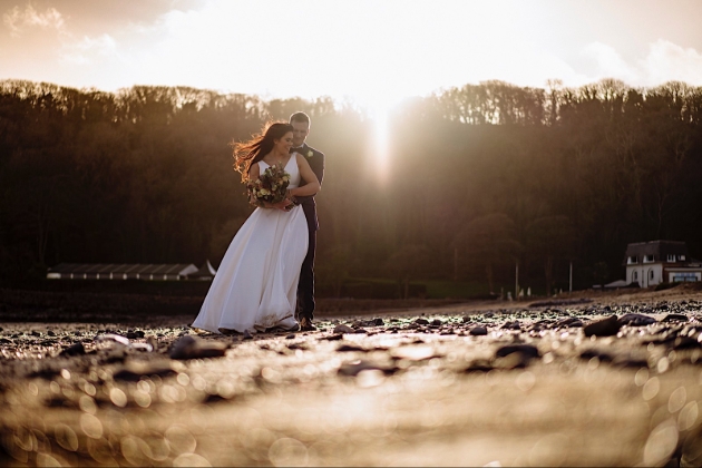 A couple on the beach embracing