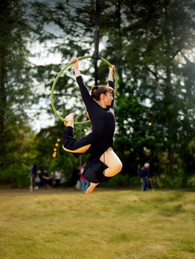 A woman jumping through a hoop in the air