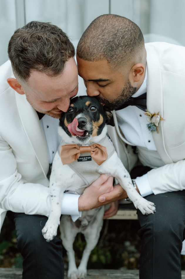 Two grooms with their pet dog
