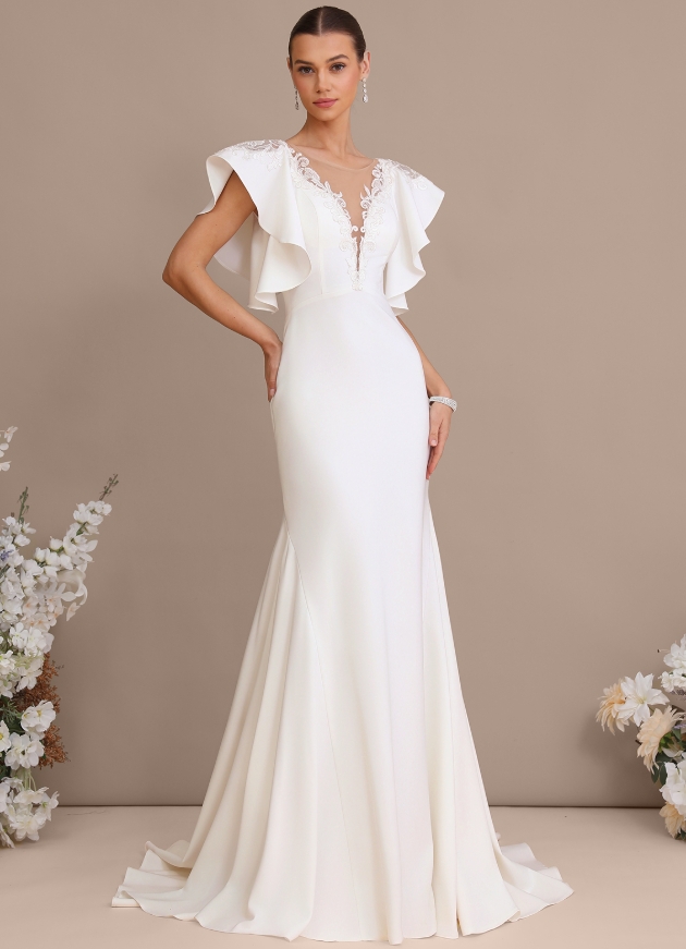 A stretch cape dress with a mermaid scoop train and elegant beading decorating an illusion back