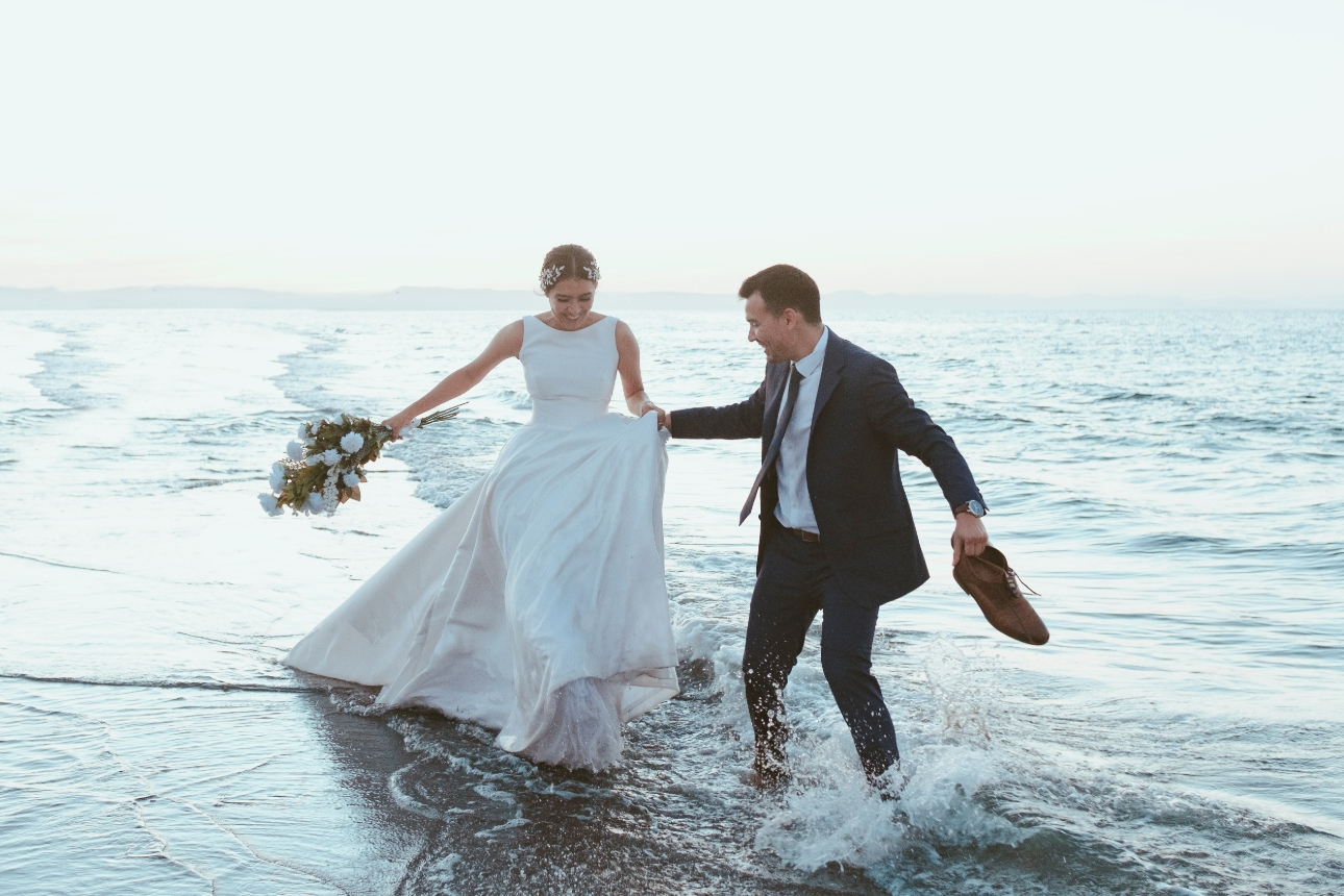 Wedding couple walking in the sea