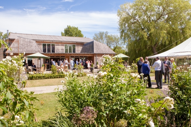 Wedding guests at the back of Houchins barn and gardens